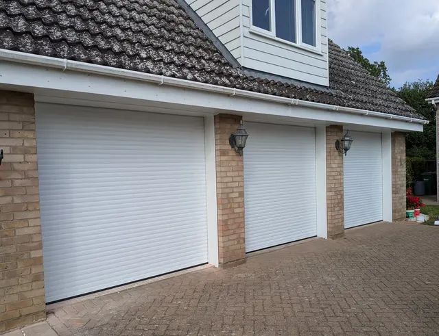 55mm white triple roller garage doors installed on an Essex property