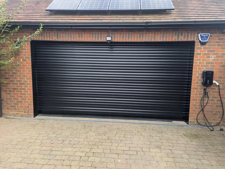 Black 77mm roller garage door fitted to a single garage