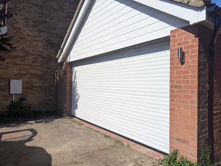 White 77mm roller garage door fitted to a single garage