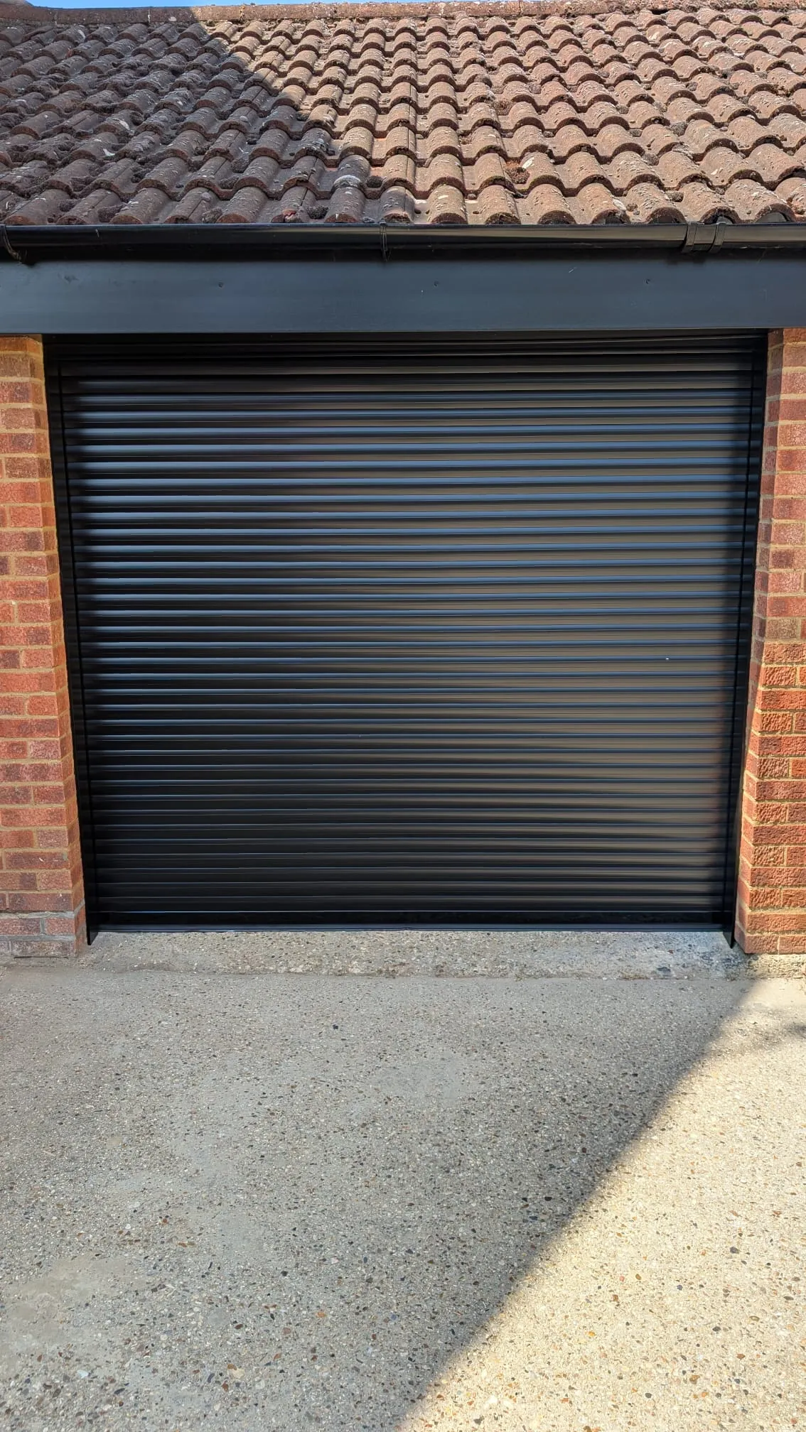 After: new black electric roller garage door fitted by Rollrite