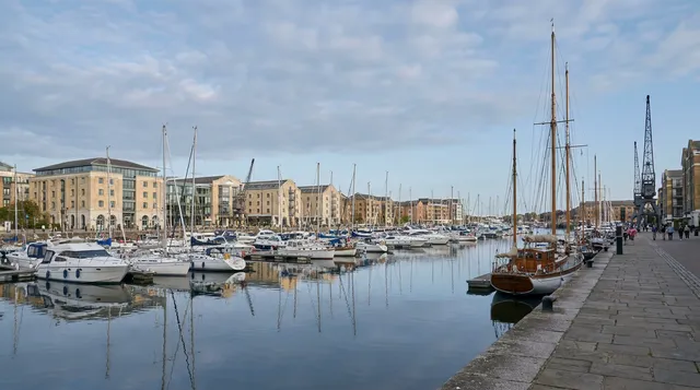 Regenerated waterfront marina with moored boats and converted quayside buildings