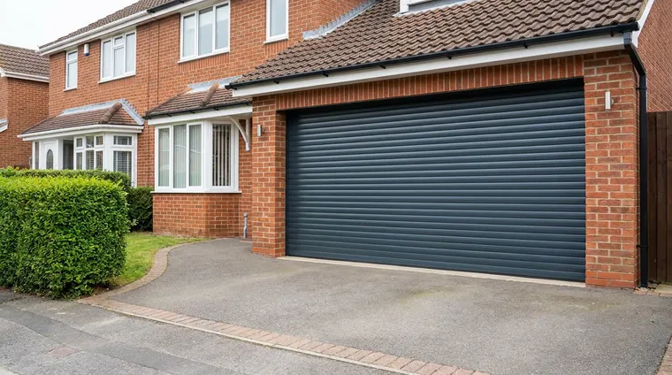 Newly fitted anthracite roller garage door on a well kept semi detached house